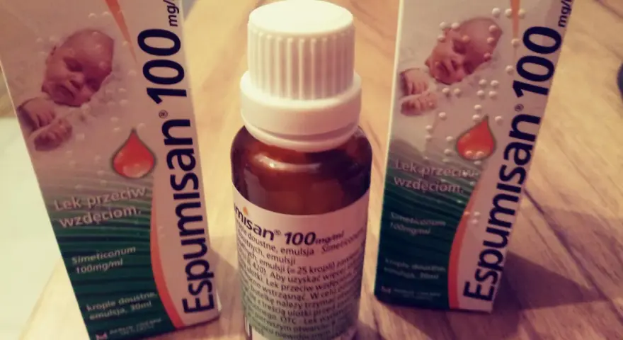 Dwie paczki i butelka Espumisan 100 mg/ml. Sprawdź espumisan 100 dawkowanie na ulotce.