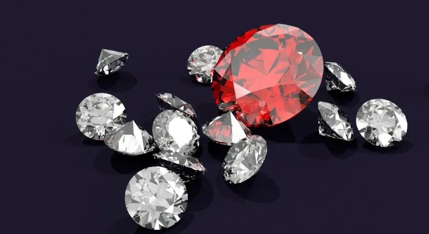 Wokół dużego, czerwonego rubinu, znanego z magicznych właściwości, rozsypane są błyszczące diamenty.