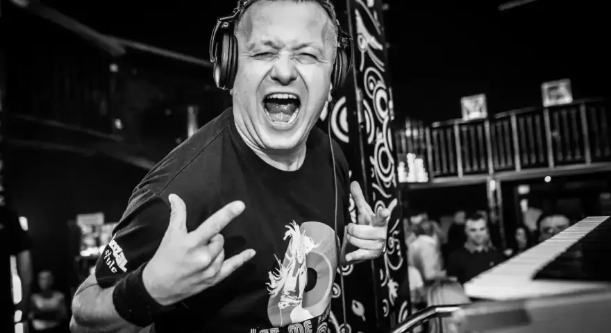 DJ Hazel z mikrofonem i słuchawkami, krzyczy do publiczności. Ile zarabia? Tego nie wiemy, ale na pewno daje czadu!
