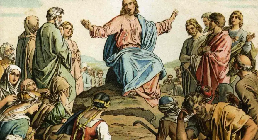 Jesus preaches the Beatitudes Catholic to a crowd gathered on a hillside, his arms outstretched in blessing.