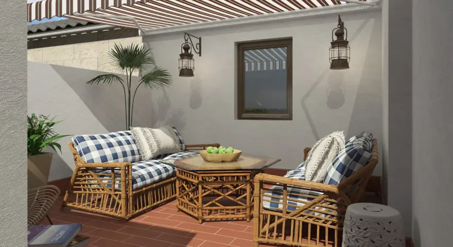 Ideas para decorar patios pequeños con poco dinero: muebles de ratán, cojines a cuadros y plantas crean un oasis acogedor.