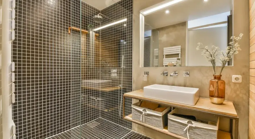 A modern bathroom with a walk-in tiled shower. Learn how to clean a walk-in tiled shower with this stylish setup.
