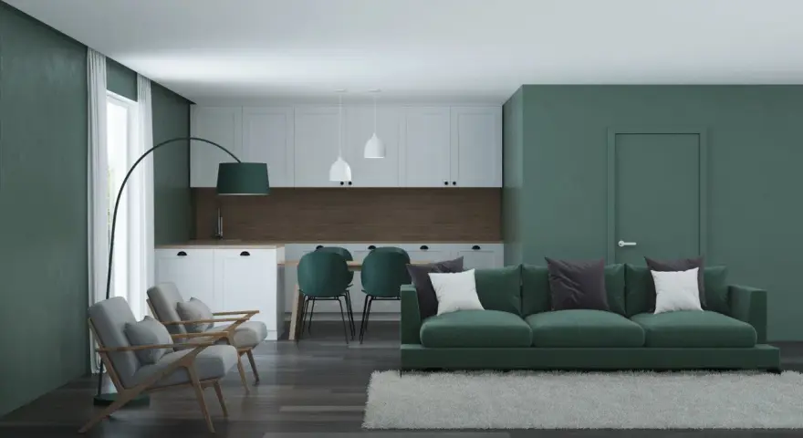 Nowoczesny salon z kuchnią w odcieniach zieleni. Seledynowy kolor ścian i mebli tworzy spokojną atmosferę.