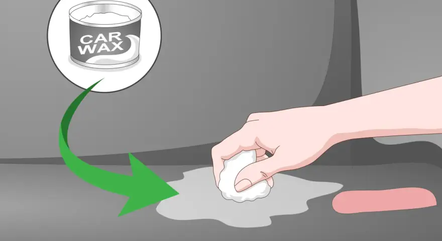 A hand applies car wax to a gray surface, showing how to remove scratches from clear plastic.
