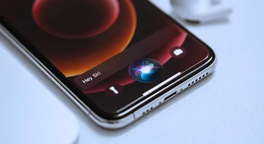 Close-up of an iPhone screen showing the Siri interface with the "Hey Siri" prompt and the colorful Siri orb.