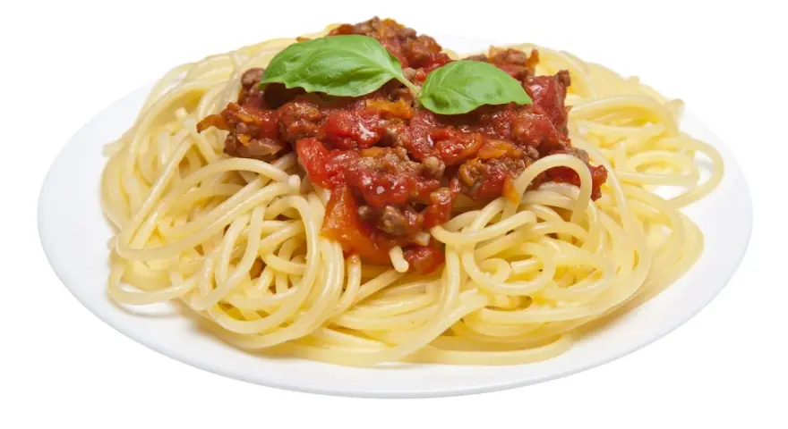 Un plato de espaguetis con carne picada y salsa de tomate, decorado con hojas de albahaca fresca. ¡Un clásico delicioso!