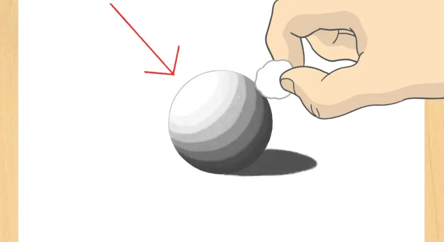 Ilustración de cómo dibujar una esfera con sombreado. Una mano difumina el sombreado con un algodón. Flecha roja indica la fuente de luz.