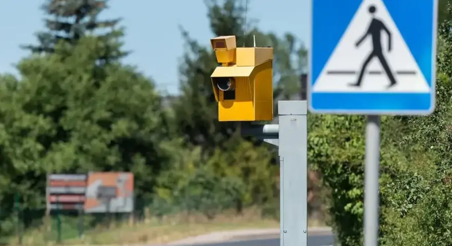 Żółty fotoradar i znak przejścia dla pieszych. Uważaj na przekroczenie prędkości o 30 w terenie zabudowanym, bo możesz dostać mandat.