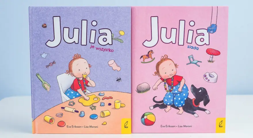Skandynawskie książki dla dzieci "Julia je wszystko" i "Julia siada" z uroczymi ilustracjami.