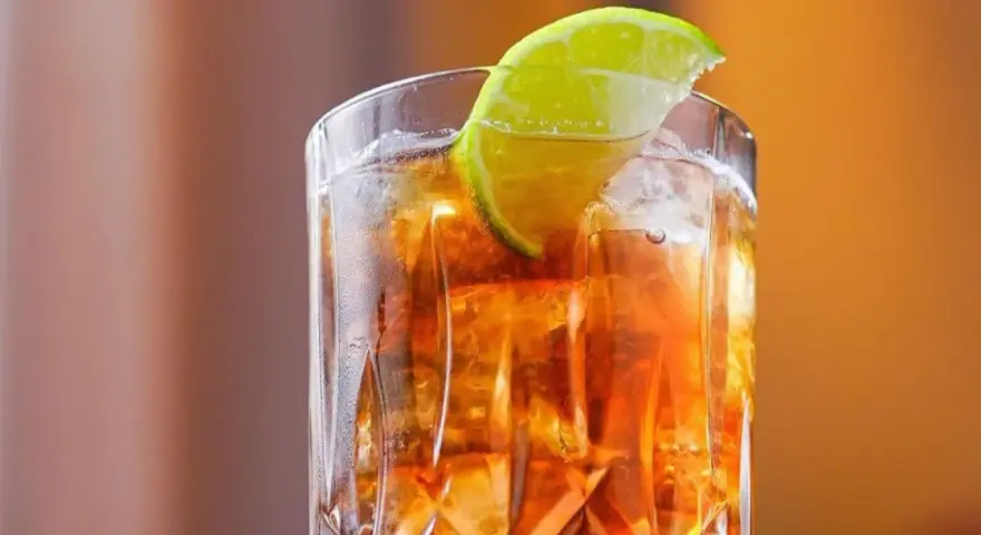 Orzeźwiający Long Island drink z lodem i plasterkiem limonki, idealny na letnie wieczory.