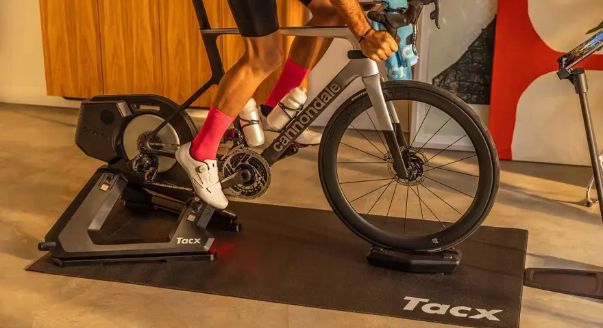 A cyclist trains indoors on a Tacx bike trainer, a device that allows you to ride your bicycle stationary.