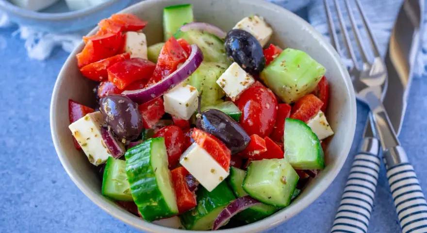 Frischer griechischer Salat mit Tomaten, Gurken, Paprika, roten Zwiebeln, Oliven und Feta – einer der 10 besten Salate für heiße Tage.
