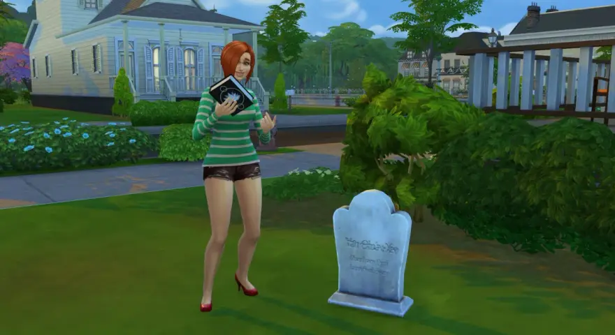 Simka z książką w ręku przy grobie, jakby szukała kodów do The Sims 3.