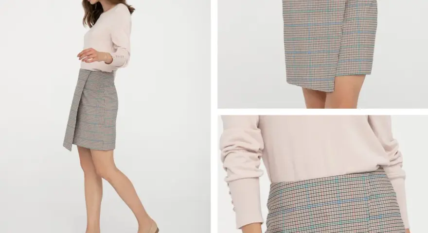 Kratka na spódniczce to ponadczasowy trend. Modelka prezentuje stylową, asymetryczną spódniczkę w kratkę, która z pewnością jest modna.