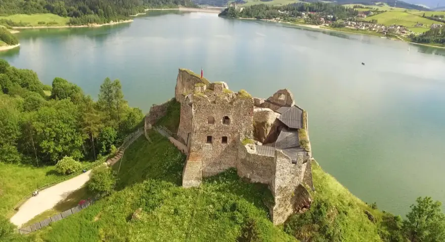Ruiny zamku na wzgórzu nad jeziorem, wspaniałe tatry słowackie atrakcje.