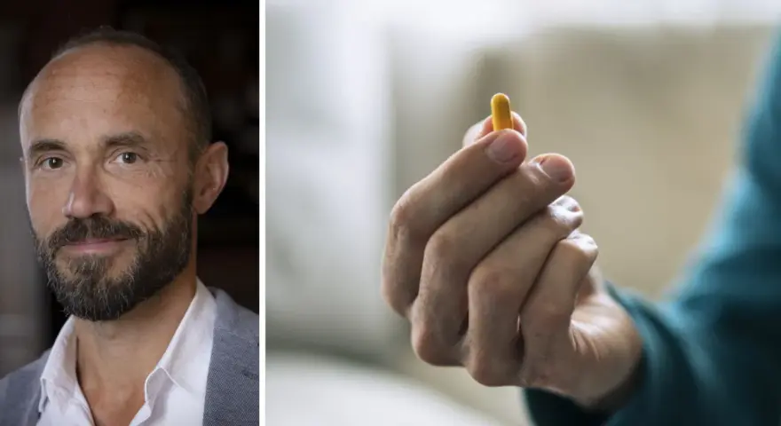 Man med skägg och en gul kapsel i handen. Kanske en illustration till vad betyder psykos.
