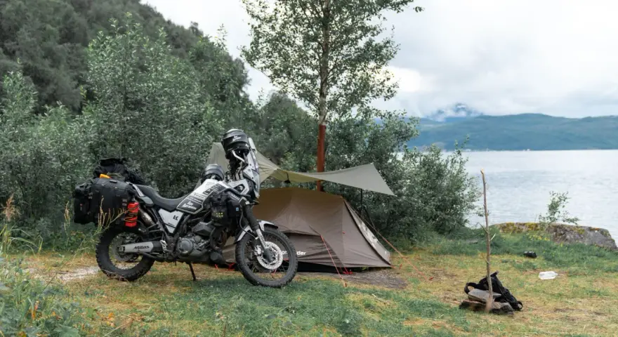 Motocyklem pod namiot nad jeziorem. Przygotowania do noclegu w dziczy.