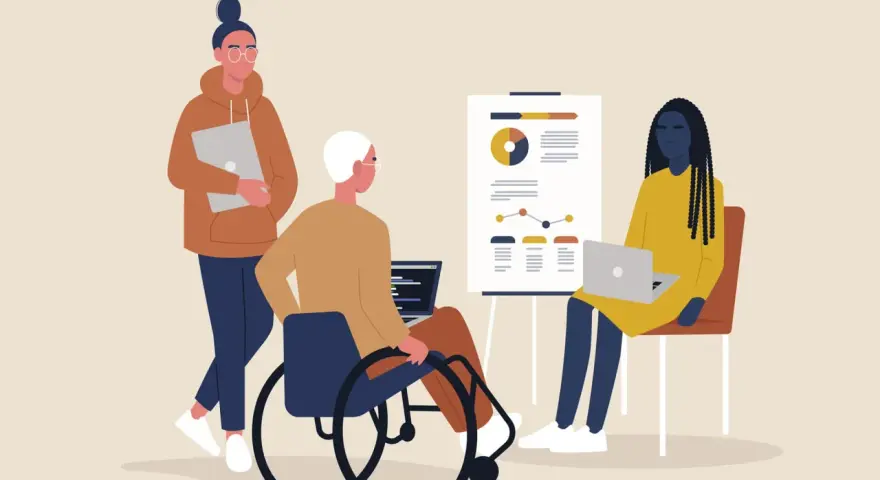 Tre personer vid ett möte. En i rullstol, en med laptop och en med en annan laptop. Känslan av psykisk misshandel på jobbet kan uppstå i sådana situationer.
