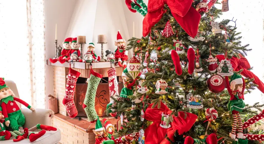 Albero di Natale addobbato con elfi e calze appese al camino. È il momento perfetto per pensare a quando fare albero di Natale!