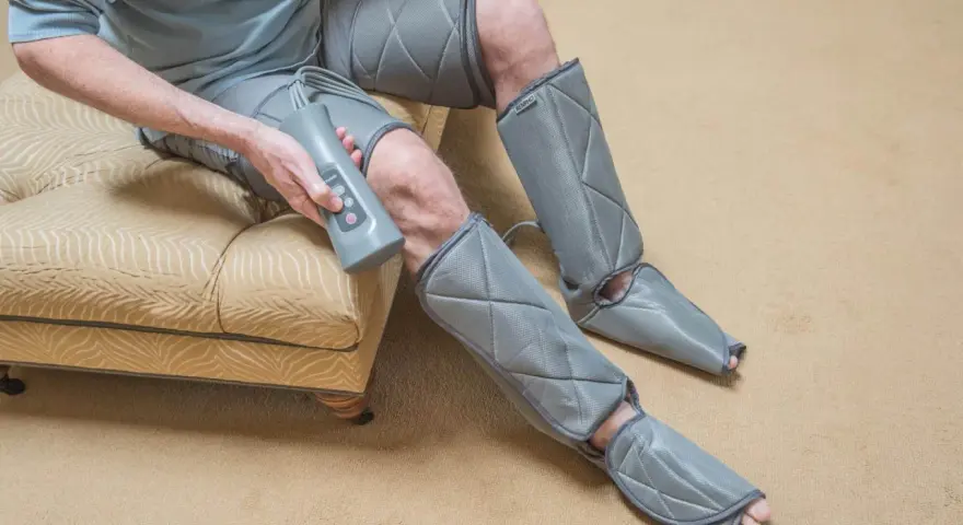 Man using a leg compression machine, enjoying the benefits of improved circulation and muscle recovery.