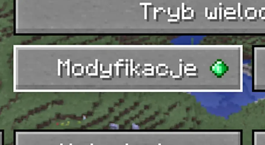 Ekran gry Minecraft z przyciskiem "Modyfikacje" i zielonym szmaragdem.