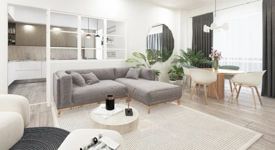 Soggiorno moderno con divano grigio, tavolino rotondo e cucina a vista. L'arredamento minimalista e i toni neutri evocano un caldo **stile nordico**.
