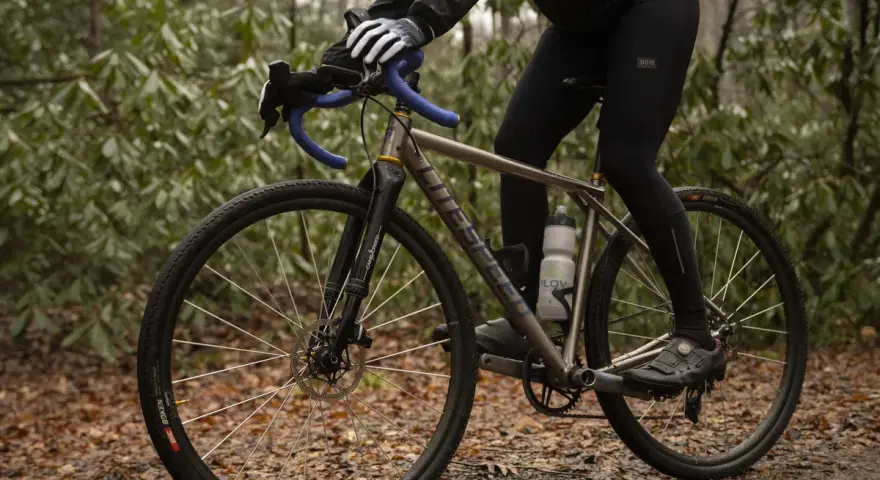 Cyclist adjusting saddle height to prevent calf pain.