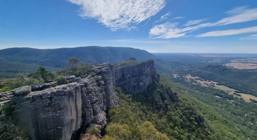 Majestatyczne australijskie góry Grampians z klifami i zielonymi dolinami pod błękitnym niebem.