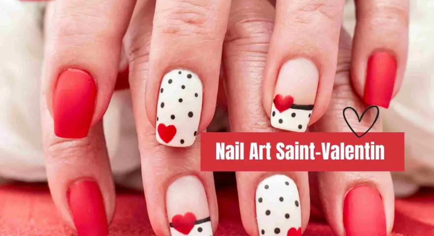 Manucure festive pour la Saint-Valentin : ongles rouges unis et ongles blancs à pois noirs et cœurs rouges.