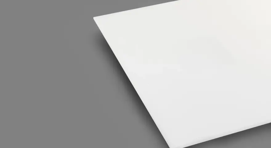 A white sheet of plexiglass is shown on a gray background. This material is known for being heat resistant, making it suitable for various applications.
