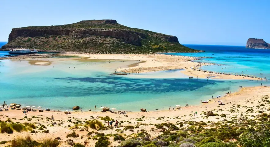 Balos Lagoon, Crete, Greece: turquoise waters, sandy beaches, and a dramatic island backdrop make this the best island in Greece for a perfect beach day.