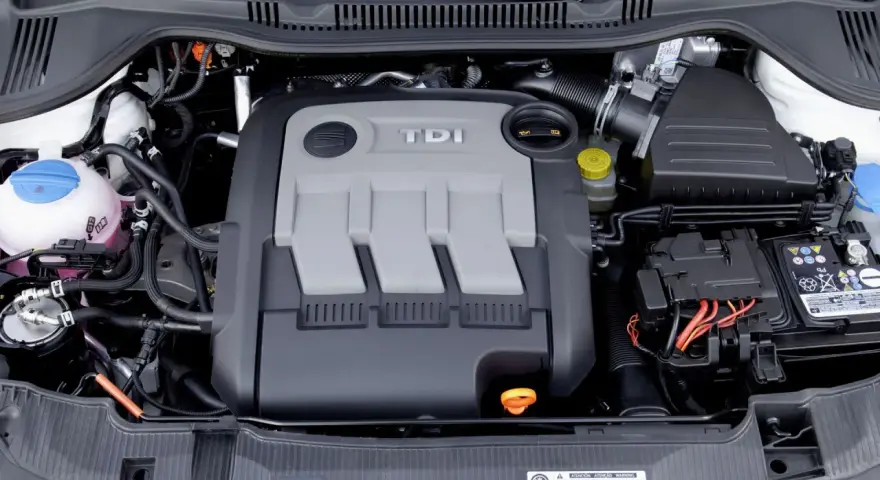 Silnik 1.4 TDI z widocznym osprzętem, akumulatorem i płynem chłodniczym.