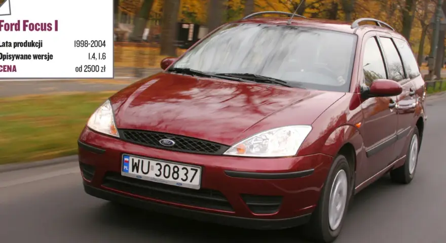 Czerwony Ford Focus Mk1 1.6 benzyna z lat 1998-2004, poruszający się po drodze.