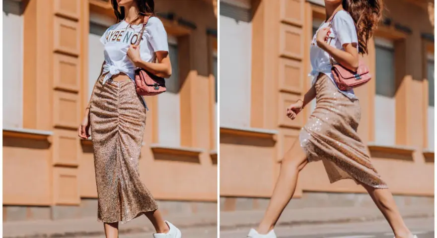 Kobieta w błyszczącej spódnicy i białej koszulce prezentuje miejski styl. Jej stylizacja to kwintesencja street fashion.