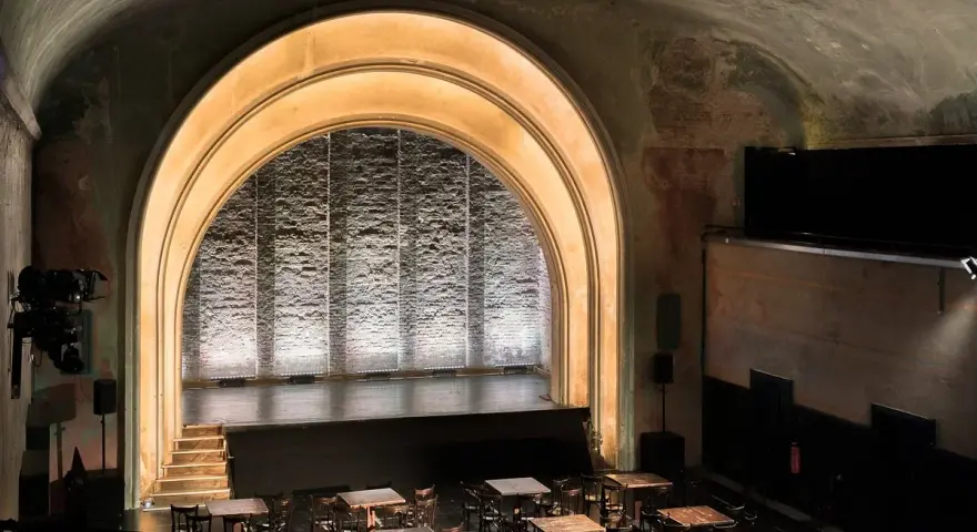 Das **Theater im Delphi** mit seiner beeindruckenden Bogenarchitektur und der beleuchteten Bühne lädt zu unvergesslichen Vorstellungen ein.