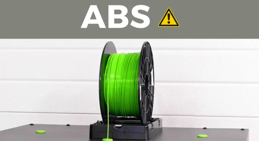 A spool of bright green ABS plastic filament, commonly used for 3D printing durable parts.