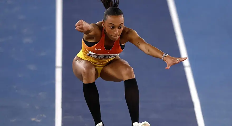 Ana Peleteiro en pleno triple salto, concentrada y en el aire, lista para aterrizar.