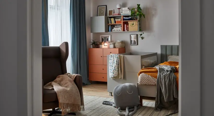 Jak przygotować stylowy kącik dla dzieci który nie psuje estetyki sali? Wygodny fotel, łóżeczko i półki tworzą przytulne miejsce.