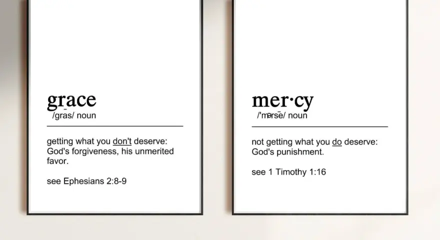 Two framed prints define "grace" as unmerited favor and "mercy" as not getting what you deserve, illustrating the contrast between grace vs mercy.