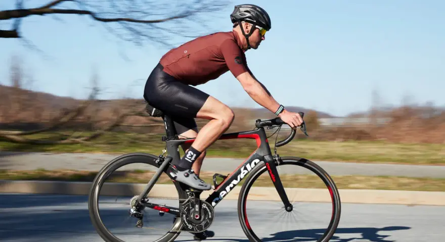 Cyclist in motion, demonstrating optimal road bike seat height for efficient pedaling.