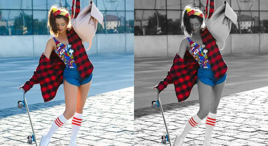 Jeune femme avec un skateboard, chemise à carreaux rouge, short en jean et chaussettes rayées. La photo présente une désaturation partielle, mettant en valeur les couleurs vives de sa tenue.