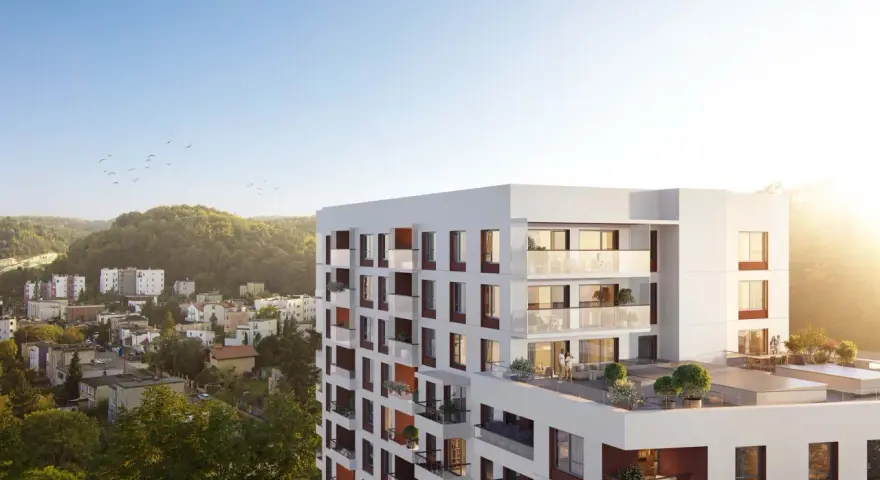 Nowe inwestycje Gdynia: nowoczesny apartamentowiec z tarasami i widokiem na zieleń.