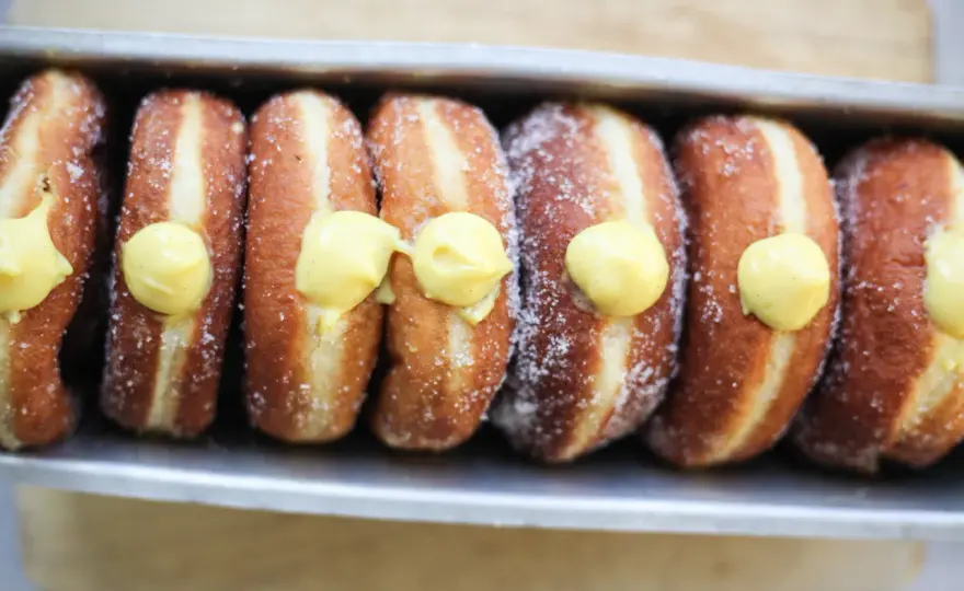 Bomboloni alla crema soffici e dorati, come in pasticceria