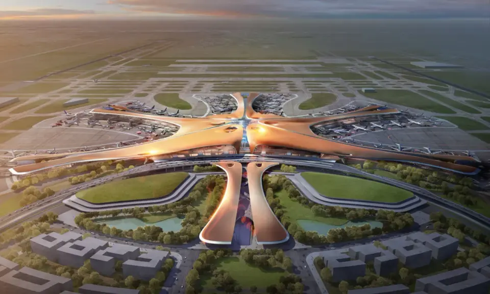 Futurystyczny terminal lotniczy, przypominający rozgwiazdę, z licznymi samolotami na płycie. To wizja największego lotniska na świecie.