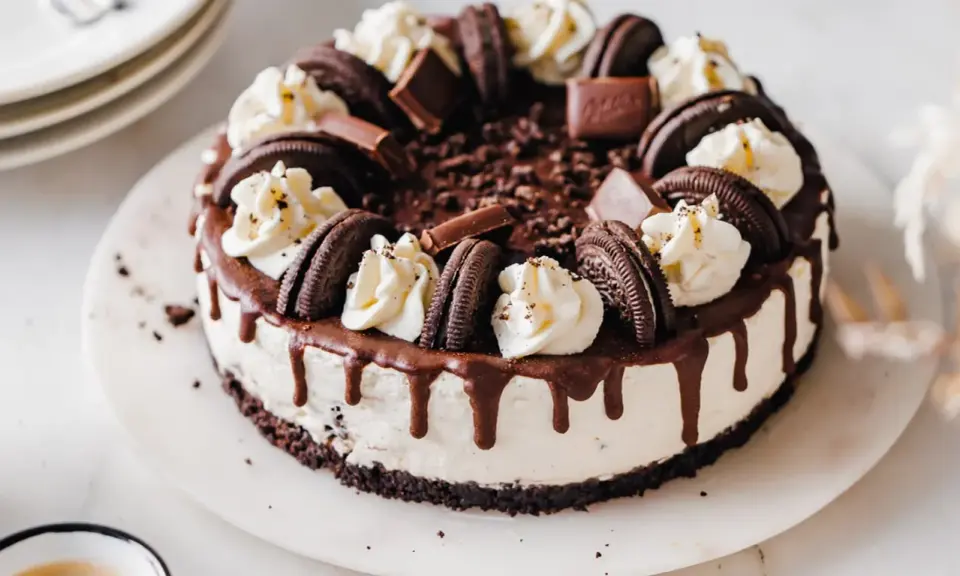 Ein köstlicher Oreo Cheesecake mit Schokoladenglasur und Sahnetupfern. Perfekt für jeden Schokoladenliebhaber.