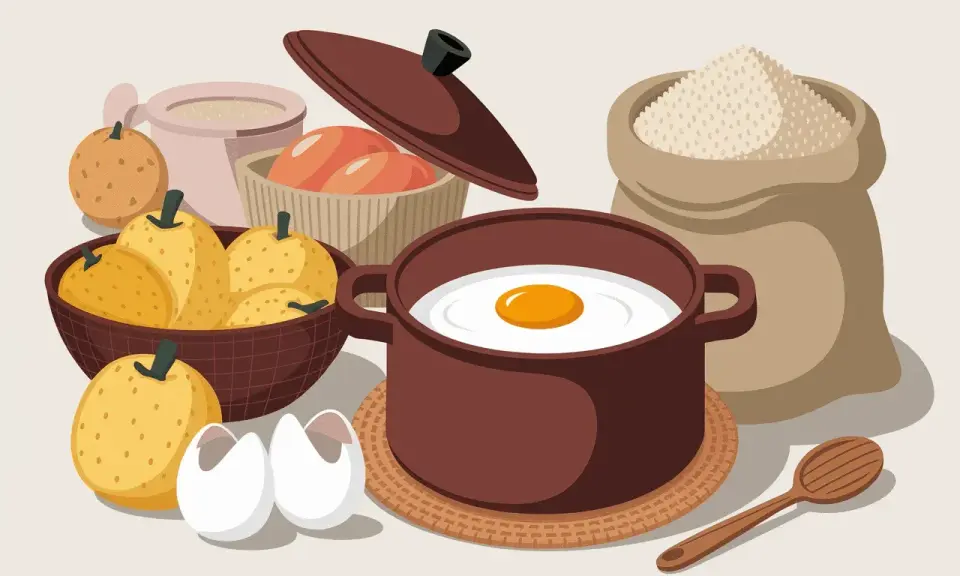 Ingrédients pour une spécialité auvergnate : poires, œufs, farine et une omelette en préparation.