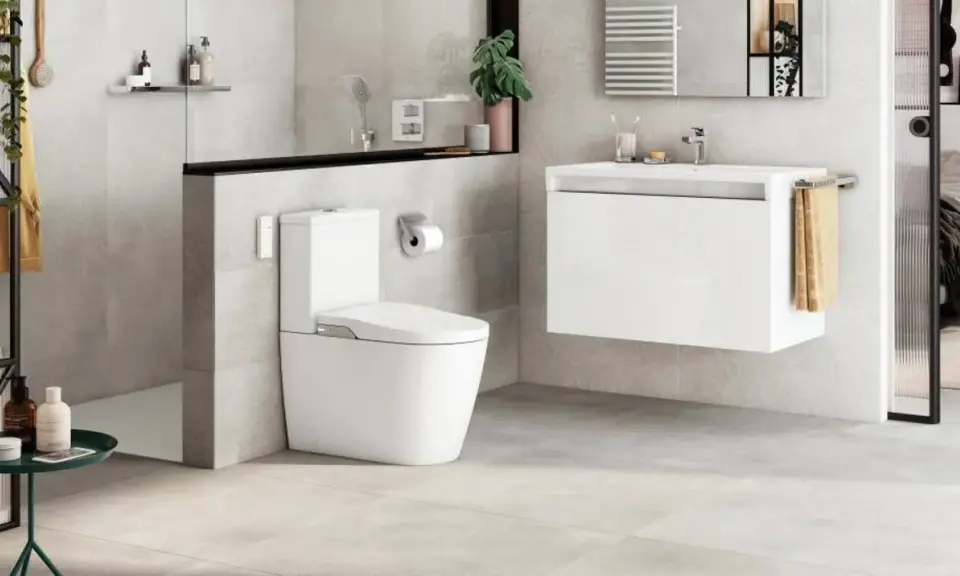 Modern bathroom with toilet and sink. A sleek design that makes you want to quitar bidet.