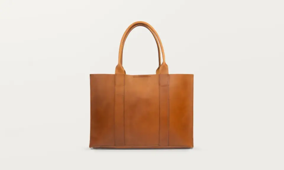 Brązowa, skórzana torebka typu shopper. Dowiedz się, jak wyczyścić skórzaną torebkę domowym sposobem, by wyglądała jak nowa.