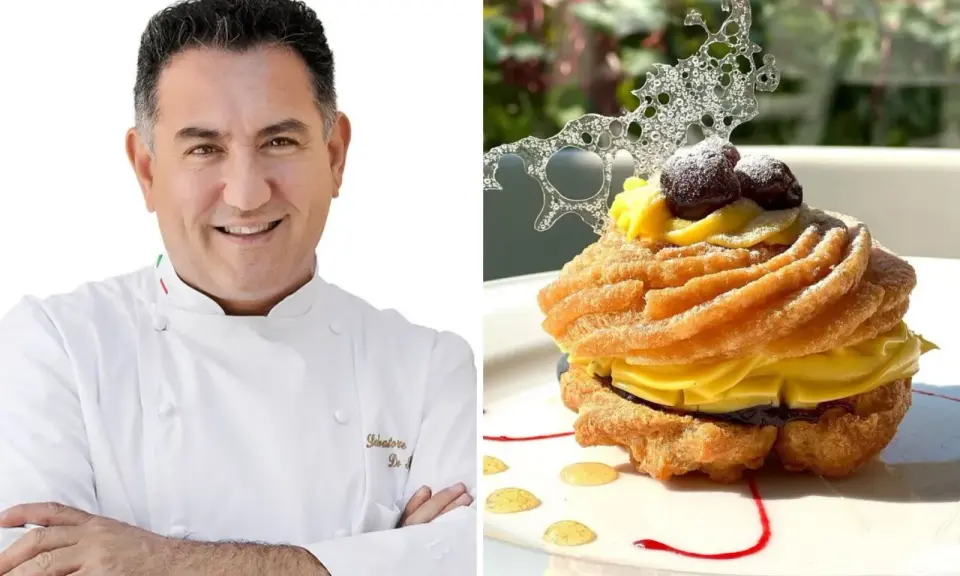 Chef sorridente accanto a una deliziosa zeppola di San Giuseppe, guarnita con crema pasticcera, amarene e decorazione di zucchero.