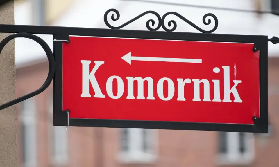 Tabliczka "Komornik" z białą strzałką w lewo. Zastanawiasz się, ile komornik może zabrać z emerytury?